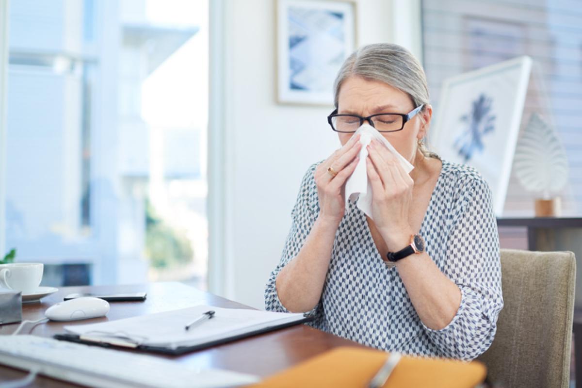 A woman covering her nose with handkerchief