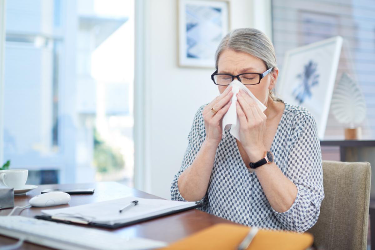 A woman covering her nose with handkerchief