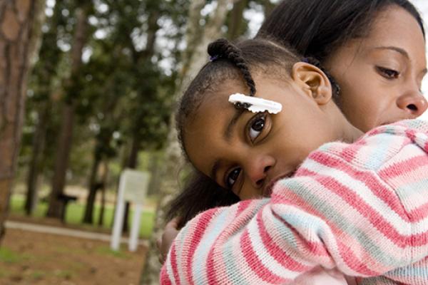 little girl cuddling an adult