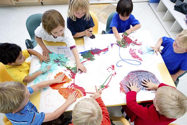 aerial view of children painting whilst sat around a table