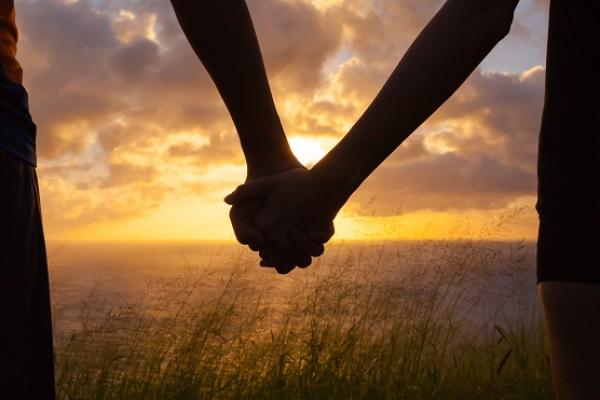 Couple holding hands in the sunset